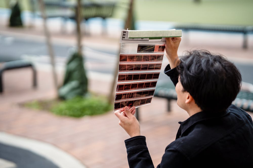 a man trying to figure out how to Spot and Repair Damaged Negatives Before Scanning