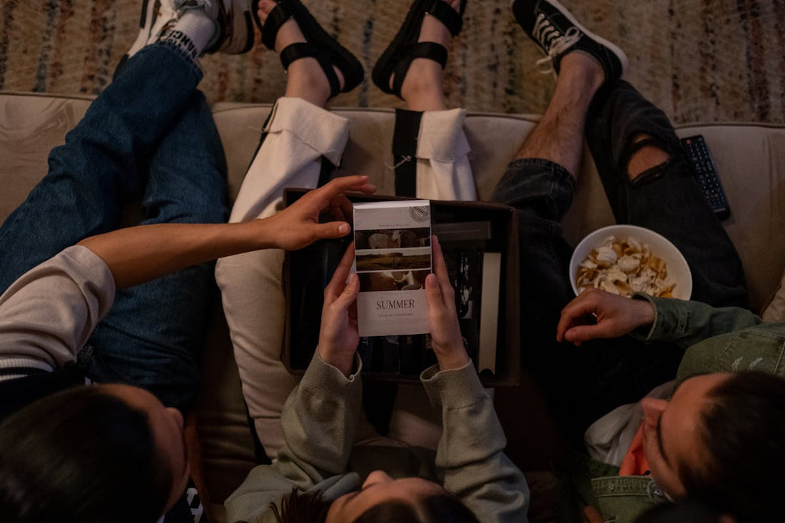 Directly above three friends choosing movie to watch