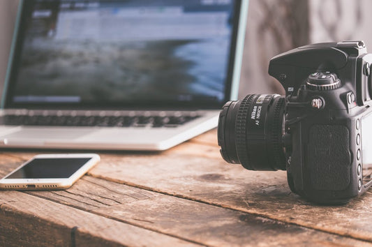 Black Camera on Beige Wooden Surface